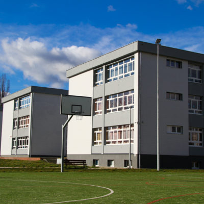 Zdjęcie przedstawia budynek szkoły do strony boiska.